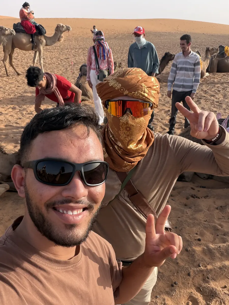 Our Morocco Zaino guide with travellers in the Sahara