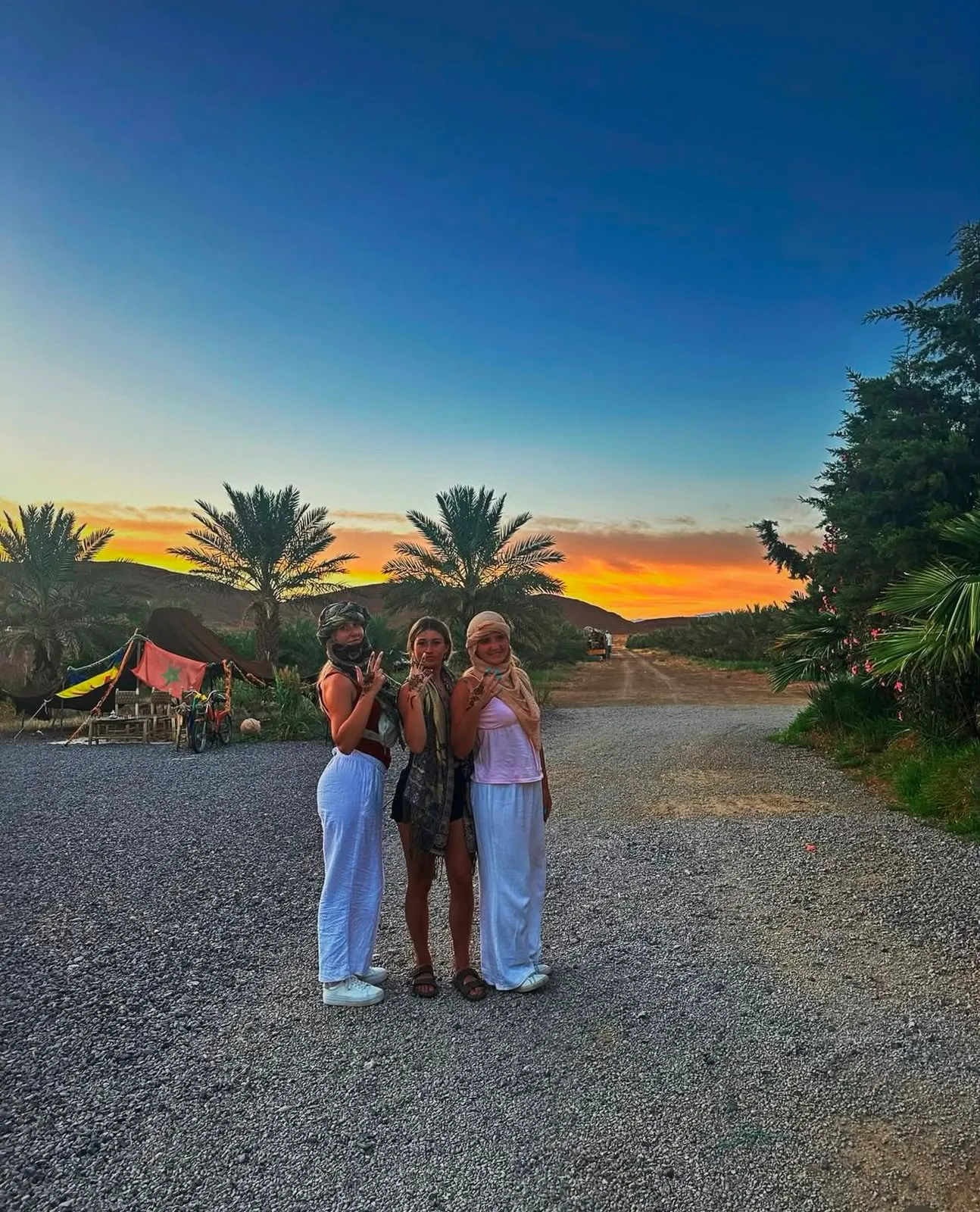 Couple watching the sunset from a dune in Erg Chebbi on a romantic Sahara trip