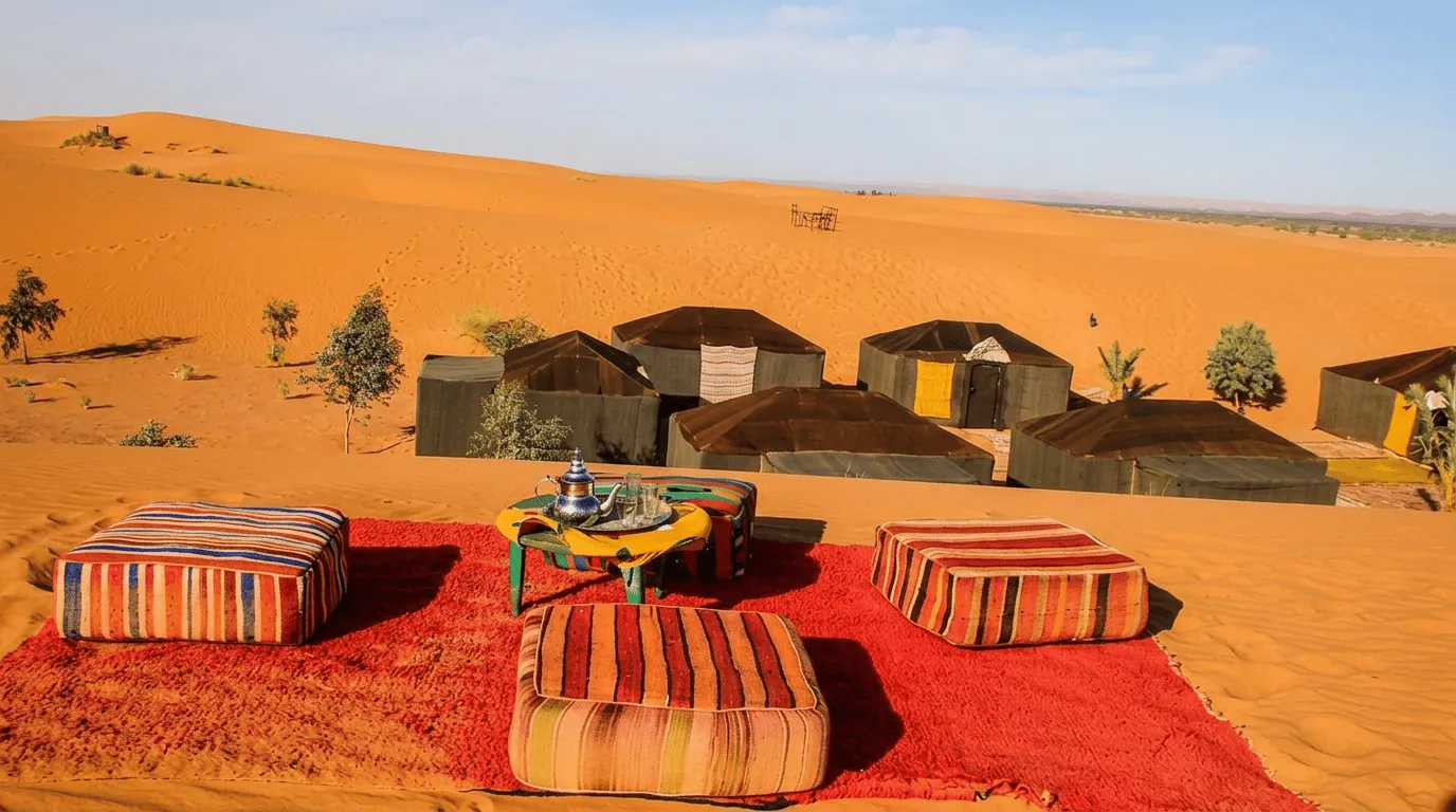 Private Dinner Under the Stars in the Sahara Desert Candlelit table for two set on the sand among dunes at dusk in the Sahara near Merzouga